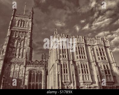 Une vue extérieure de l'église Saint Jean Baptiste de Cirencester, Gloucestershire, Angleterre. À gauche est la tour du Xvème siècle. Sur la droite est le grand porche sud. Crédits photos - © COLIN HOSKINS. Banque D'Images
