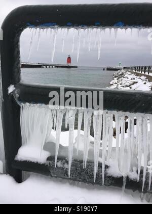 À la lumière de la jetée sud Station dans Charlevoix, Michigan par une balustrade encadrée par les glaçons. Banque D'Images