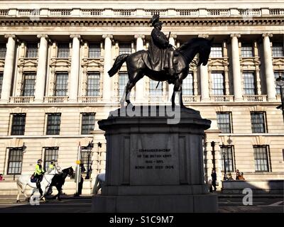 Deux officiers de la police montée descente de Whitehall passé une statue du duc de Cambridge à Londres Mars 2017. Banque D'Images