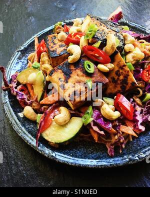 Pan-fried tofu épicé avec des sanglots et salade de nouilles, sauce aux arachides Banque D'Images