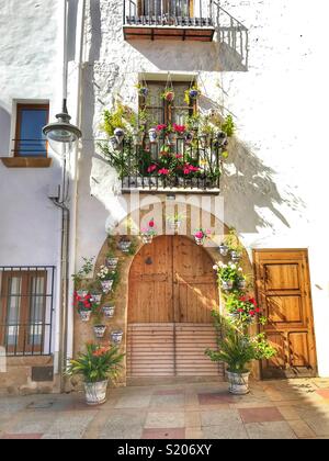 Une maison de ville décorée avec des plantes en pot à fleurs autour de la porte et sur le balcon dans la vieille ville de Javea/Xabia, Alicante, Espagne Banque D'Images