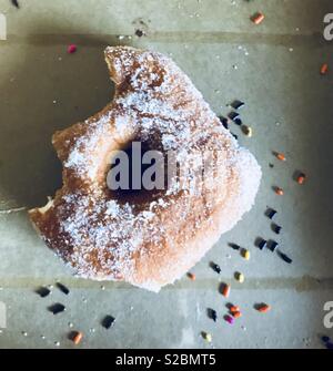 Saupoudrer de sucre partiellement mangés donut Banque D'Images