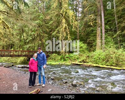 L'homme et de la femme devant des flux, Olympic National Park, Washington Banque D'Images