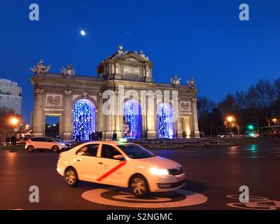 Taxi et porte Alcala, vue de nuit. Madrid, Espagne. Banque D'Images