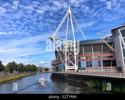 Principauté Stadium, Cardiff Central, accueil de Rugby gallois, avec un bateau de plaisance sur la rivière Taff. Banque D'Images