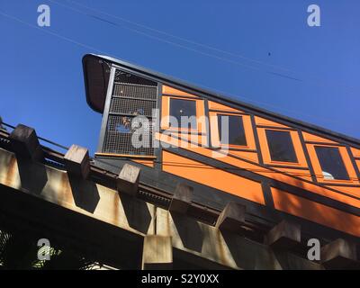 LOS ANGELES, CA, AOÛT 2019 : ciel bleu avec l'orange vif Angels Flight funiculaire passant en voiture du centre-ville de Bunker Hill Banque D'Images