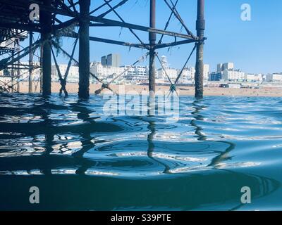 Vue sur la plage de Brighton depuis le dessous de la jetée Banque D'Images