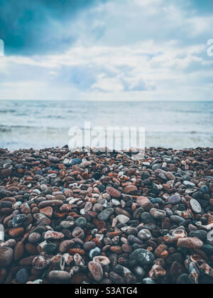 Galets sur une plage de stoney au bord de la mer. Banque D'Images
