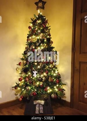 Arbre de Noël entièrement décoré dans un salon britannique. Banque D'Images