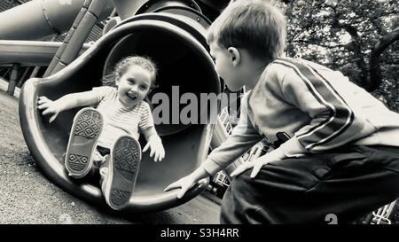 petite fille qui descend avec un petit garçon qui regarde Banque D'Images