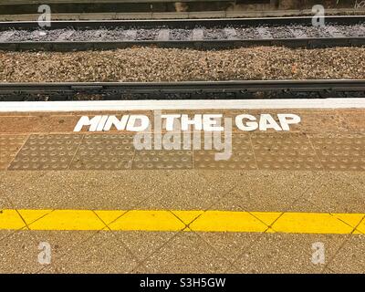 Attention au signe Gap au bord d'une gare avec la voie en arrière-plan Banque D'Images