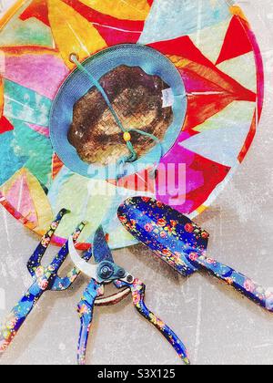 Les outils d’une jardinière féminine pour l’activité dans son jardin – un chapeau de paille coloré, des sécateurs de fleurs, une bêche et une griffe. Effet grunge ajouté numériquement à cette vie de plein air. Banque D'Images