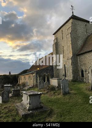 Église St Margare avec Beacon Mill au sommet de la colline en arrière-plan à Rotingdean, West Sussex, Angleterre. Banque D'Images