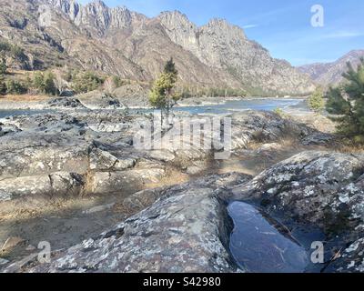 Une banque en pierre et un fond de rivière fait de roches volcaniques de lave sur la rivière Katun en Altaï Banque D'Images