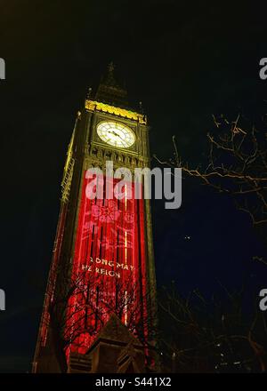 Big Ben, Elizabeth Tower, une partie du Palais de Westminster à Londres, décorée de « long May he Reign » pour célébrer le couronnement du roi Charles III à Londres. Veilleuses. Arborescence en arrière-plan Banque D'Images