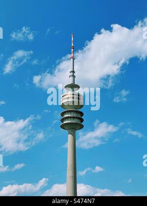 Tour Olympiaturm à Olympiapark, Munchen, Allemagne au-dessus d'un ciel bleu avec des nuages blancs par une journée ensoleillée Banque D'Images