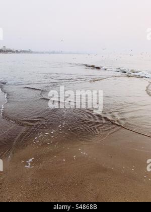 Plage avec textures des vagues au premier plan Banque D'Images