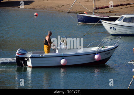 Direction d'un pêcheur d'un petit bateau de pêche à Gorey Harbour sur l'île de Jersey, Îles britanniques, Royaume-Uni. Banque D'Images