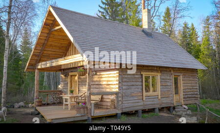 La maison en bois nouvellement construit sur la forêt avec toujours pas de peinture sur elle et les arbres entourant la zone Banque D'Images