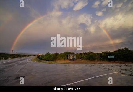 Arc-en-ciel complet au-dessus de l'entrée à l'inscription du parc national Addo en Afrique du Sud Banque D'Images