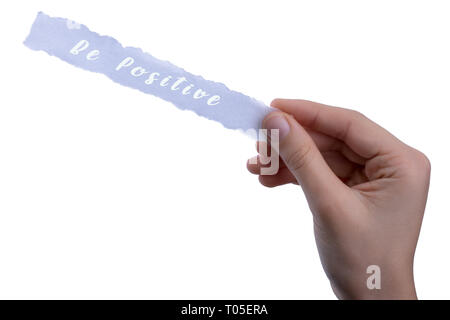 Papier déchiré par la main tenant à être pensée positive concept label Banque D'Images