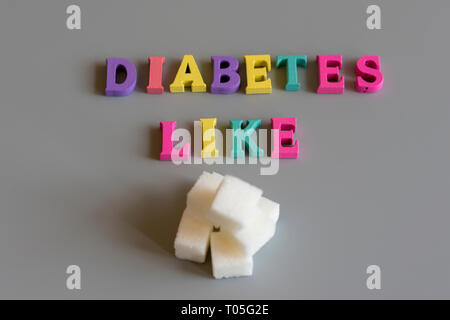Concept de maladie du diabète. L'inscription comme le diabète sucre sur un fond gris. Banque D'Images
