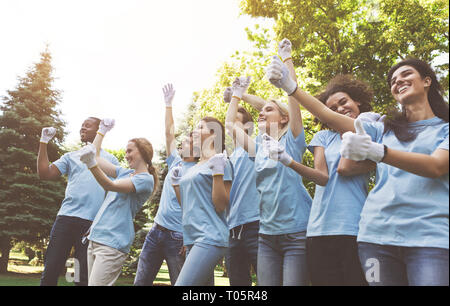 Du groupe des bénévoles heureux des succès à célébrer dans park Banque D'Images