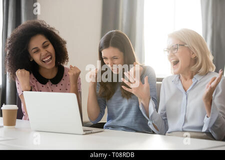 Divers professionnels de joie les femmes excitées par l'équipe de gagner en ligne Banque D'Images