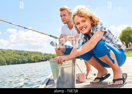 Père et fils la pêche sur le week-end au lac comme un passe-temps et de détente Banque D'Images