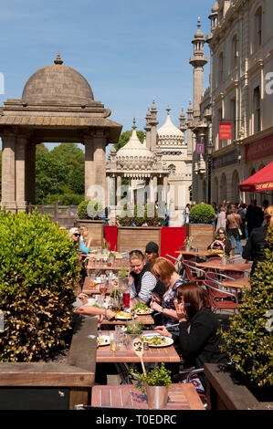 Les gens assis à l'extérieur d'un restaurant dans les ruelles de la ville balnéaire de Brighton, Sussex, Angleterre. Banque D'Images