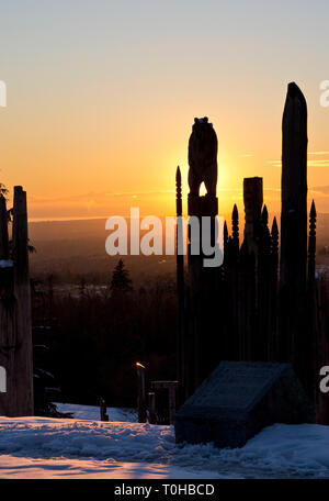 Burnaby Mountain Park en hiver. Burnaby, Colombie-Britannique, Canada. Totems Ainu japonais appelé 'Aire des dieux', rétroéclairé par le coucher du soleil. Banque D'Images