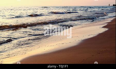 Plage Coucher de soleil avec des vagues se brisant sur le rivage, au cours de l'été sur le lac Huron en Ontario, au Canada. Banque D'Images