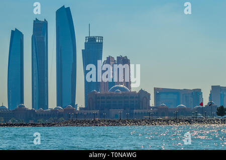 La ville d'Abu Dhabi Corniche le long beach prises à partir d'un bateau en eau Banque D'Images