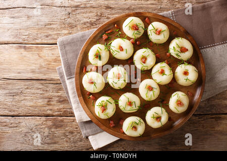 Des boulettes de pommes de terre aux lardons et oignons verts close-up sur une plaque sur la table. haut horizontale Vue de dessus Banque D'Images