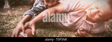 Happy Family playing rugby ball in yard Banque D'Images