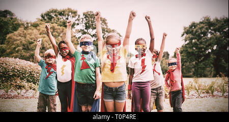 Enfants wearing superhero costume standing Banque D'Images