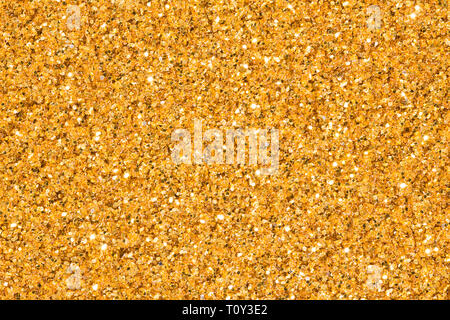 Light golden glitter avec brio. Texture glitter doré brillant. Banque D'Images