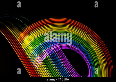 Les lumières multicolores sur fond noir. Arc-en-ciel de couleurs vives les courbes. L'espace pour écrire. Symbole gay LGBT Banque D'Images