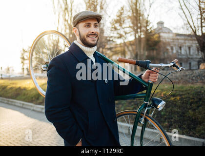 Old fashioned Bicycle Rider avec le vélo sur l'épaule Banque D'Images