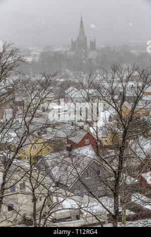 Voir à la recherche sur les toits vers l'église dans la ville de Trondheim en Norvège, pendant une tempête de neige. Banque D'Images