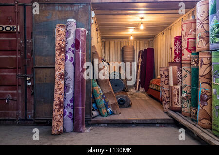 Au Dordoy Bazar, l'un des plus grands marchés de gros de l'Asie à Bichkek, au Kirghizistan. Tous les stands sont dans des conteneurs d'expédition. Magasin de tapis. Banque D'Images