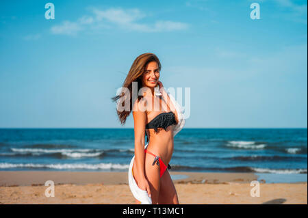 Portrait of smiling young woman wearing bikini sur la plage Banque D'Images