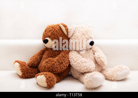 Les jouets pour enfants - ours de couleur marron et beige sont assis sur le canapé. Focus sélectif. Banque D'Images