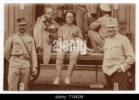 Prisonniers de guerre russes avec le convoi autrichien pendant son transport au cours de la Première Guerre mondiale dans le transport ferroviaire sur certains probablement gare dans la République tchèque moderne. Vintage noir et blanc photographie par un photographe inconnu. Avec la permission de l'Azoor Photo Collection. Banque D'Images