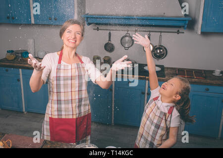 Jouer avec la farine. La cuisson des gâteaux. Heureux famille aimante préparent ensemble la boulangerie. Mère et enfant fille fille sont la cuisson des cookies et Banque D'Images