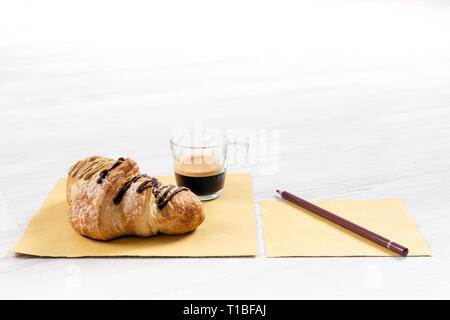 Brioche gourmande avec du chocolat et farci à la pistache sur une table en bois Banque D'Images