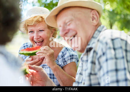 Happy senior couple sur une sortie nature en mangeant melon Banque D'Images