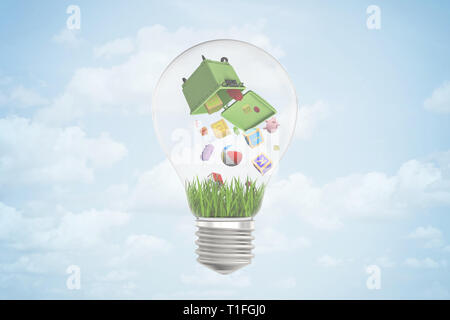 Le rendu 3D de l'ampoule avec corbeille à l'envers à l'intérieur, à partir de laquelle les jouets et autres objets tombent sur l'herbe à l'intérieur de l'ampoule. Banque D'Images