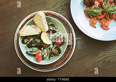 Bonne juteux des plats de fruits de mer qui se tenait à côté de lui sur la table en bois Banque D'Images