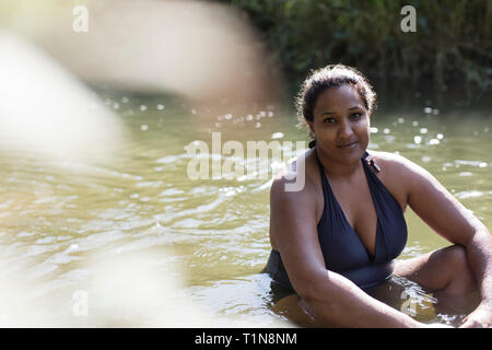 Portrait smiling woman relaxing in sunny river Banque D'Images